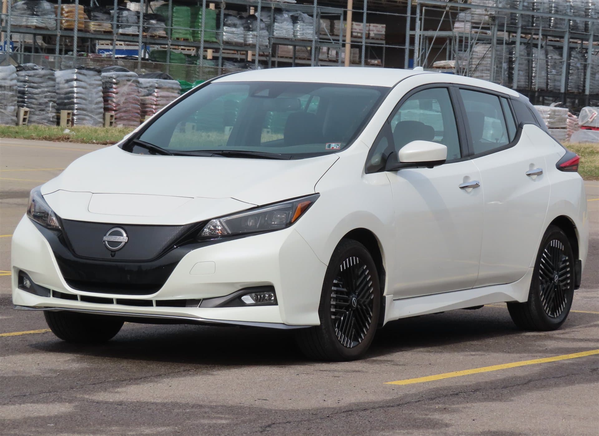Nissan LEAF electric hatchback (illustrative Leaf photo; NISMO aero and red accents differ)