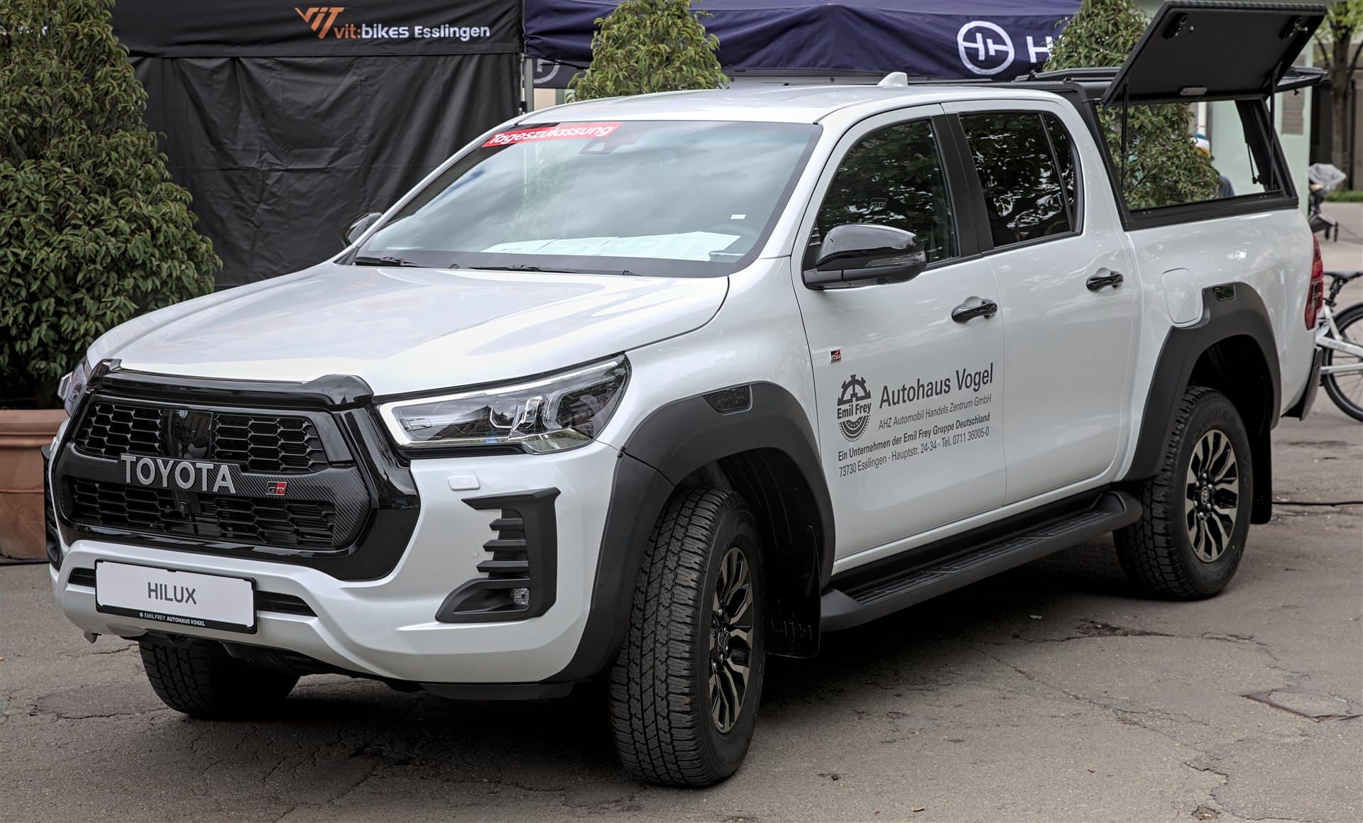 Illustrative Toyota Hilux pickup (prior-generation GR Sport shown; ninth-gen BEV design differs)
